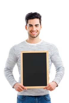 Handsome young man holding a small chalkboard, isolated over a white background