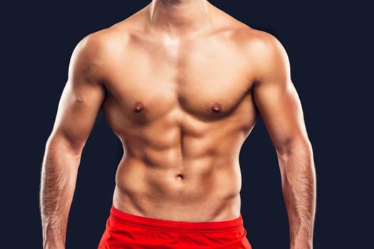 Muscular man, isolated over a gray background