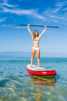 A beautiful woman practicing paddle on a beautiful sunny day