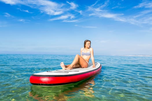 A beautiful woman practicing paddle on a beautiful sunny day