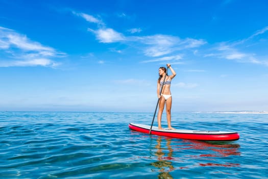 A beautiful woman practicing paddle on a beautiful sunny day