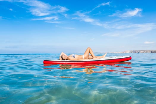 A beautiful woman practicing paddle on a beautiful sunny day