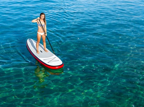 A beautiful woman practicing paddle on a beautiful sunny day