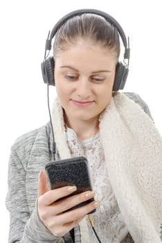 a young woman listening to music with his mobile phone and headphone