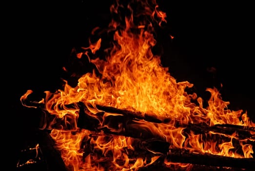 Large campfire at night while camping