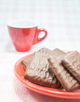Milk chocolate pieces and coffee cup, stock photo
