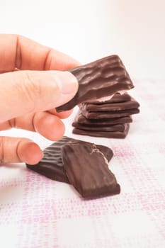 Hand on peppermint chocolate piece, stock photo