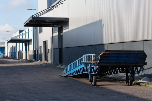 Blue mobile ramp for truck in an industrial district