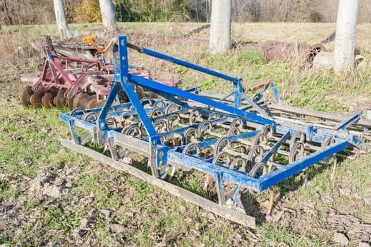 Tools for agriculture. Old blue Harrow with spring system.