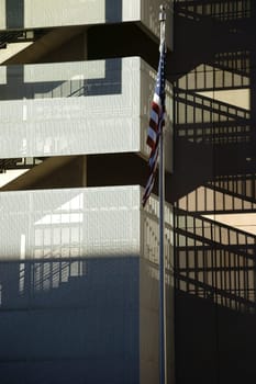 The facade of a modern residential building with a stairway that casts a shadow.