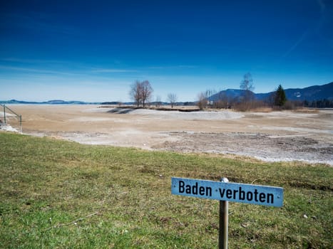 Sign with the inscription Bathing forbidden at the drained Foggensee near Füssen