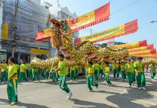 NAKHONSAWAN,THAILAND - FEBRUARY 13: Chinese New Year parade on February 13, 2013 in Nakhonsawan, Thailand. Chinese dragon dance performance for Chinese New Year Celebrations.