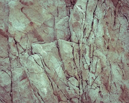 Rough stone rock texture background in vintage filter effect