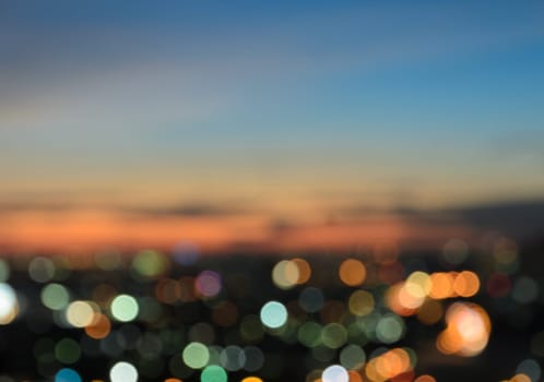 Blurred twilight sky background with colorful city lights bokeh