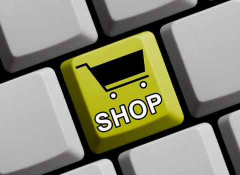 Yellow computer keyboard with shopping cart icon shows shop