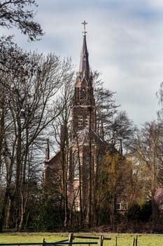 Church behind trees in winter.