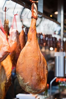 Hams hanging in a butcher’s shop.