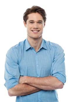 Stylish guy posing to camera with folded arms