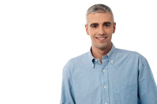 Smiling young man posing casually over white