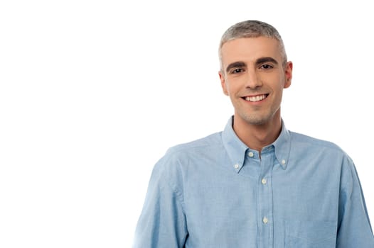 Relaxed young man posing casually over white
