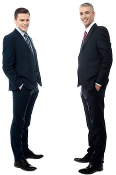 Young businessmen posing with hands in pockets