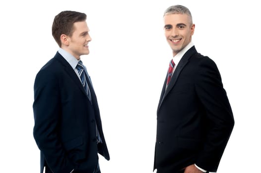 Businessmen talking to each other against white background