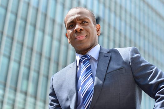 Confident business man posing outside of his office