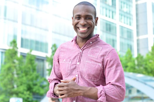 Happy african man posing casually to camera