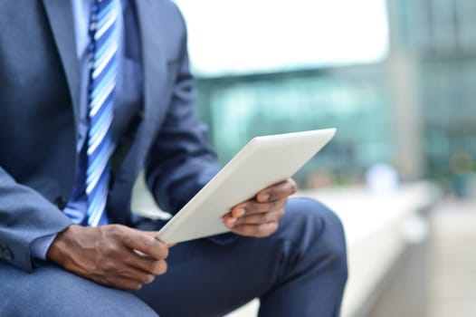Cropped image of a business man operating tablet