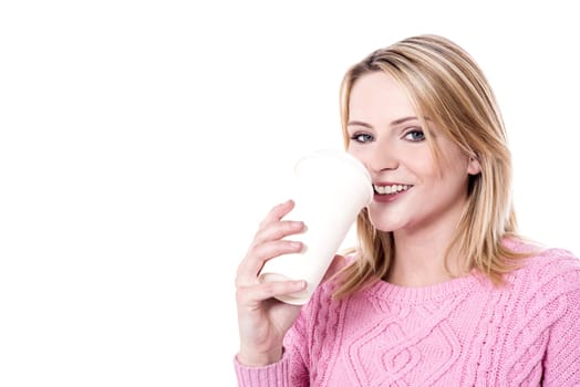 Young smiling woman having beverage