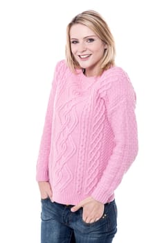Young lady posing to camera with hands in pockets