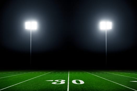 Football field illuminated by stadium lights