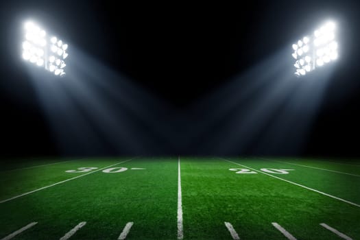 Football field illuminated by stadium lights