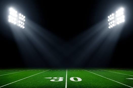 Football field illuminated by stadium lights