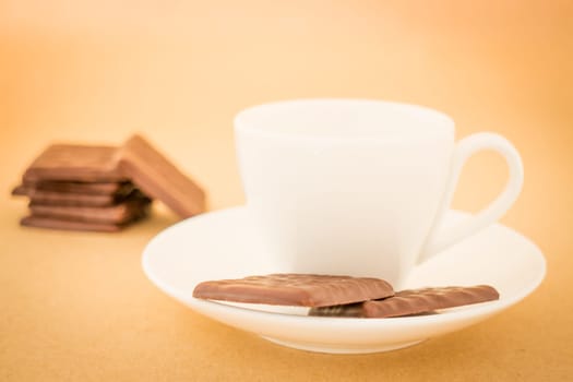 White mug of hot coffee and chocolate pieces, stock photo