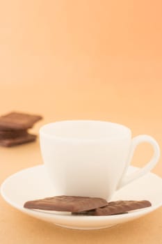 White mug of hot coffee and chocolate pieces, stock photo