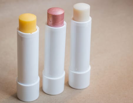 Moisturizer lipstick on brown natural background, stock photo