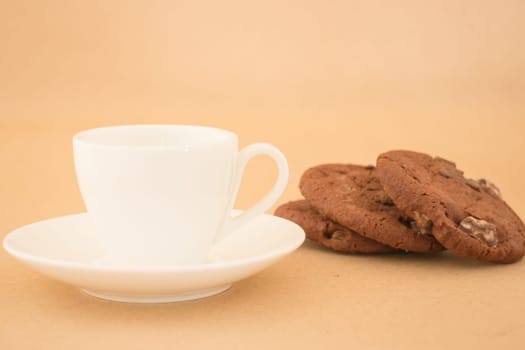 White mug of hot coffee and chocolate cookies, stock photo