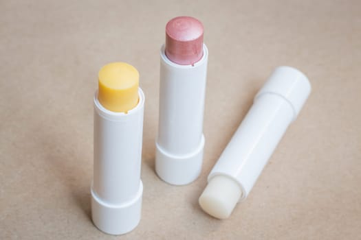 Moisturizer lipstick on brown natural background, stock photo