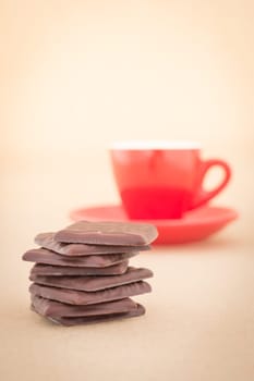 Red mug of hot coffee and chocolate pieces, stock photo