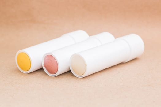 Moisturizer lipstick on brown natural background, stock photo