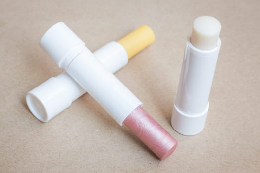 Moisturizer lipstick on brown natural background, stock photo