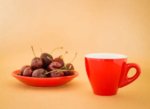 Beautiful breakfast of red coffee cup and cherries, stock photo