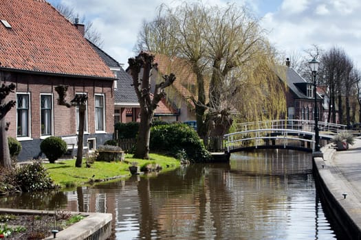 Picturesque village with antique houses next to the water in the Netherlands