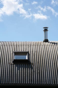 Metal roof with  window and chimney