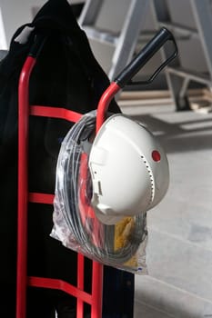 Red trolley used as a peg for hardhat and coat.
