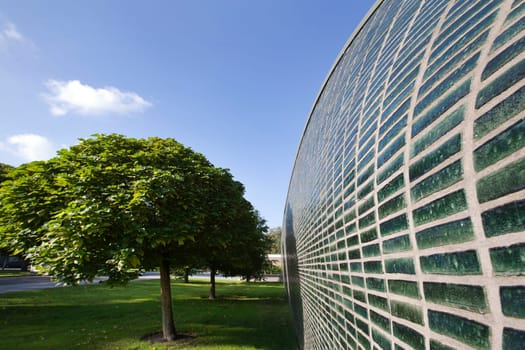 Wave shaped wall, made from green glazed bricks