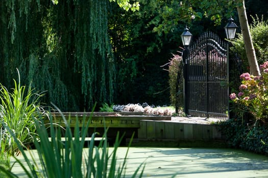 Fence entrance of a garden surrounded by water