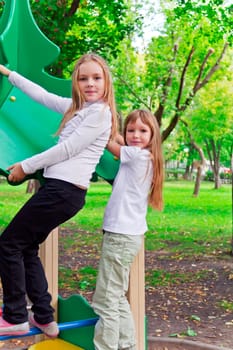 Photo of two playing girls in summer