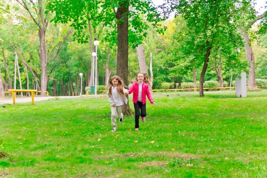 Photo of cute two running girls in summer
